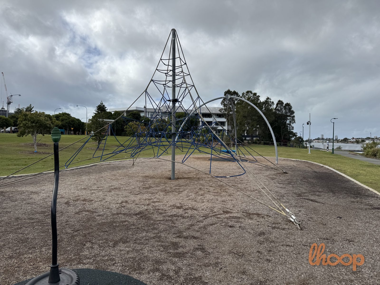 A close view of the rope climbing pyramid, with the arch swing to the left and the lakefront beyond.
